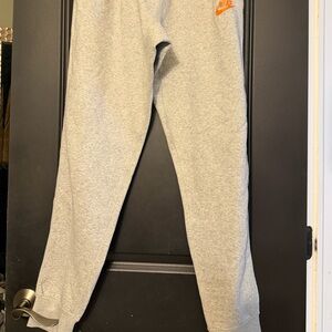 Nike Kids Grey Joggers with Orange Swoosh